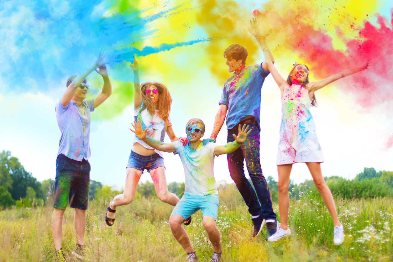 Participants throwing color powder outdoors